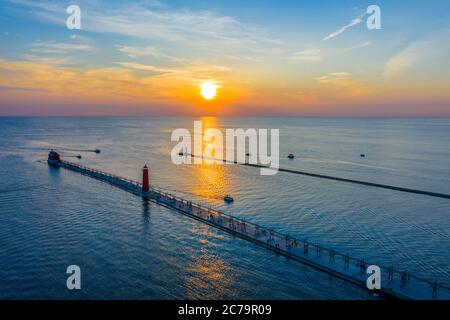 Aerial view of the Grand Haven South Pier and North Pier Lighthouses at sunset along Lake Michigan; Grand Haven, Michigan Stock Photo