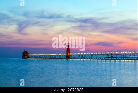 View of the Grand Haven South Pierhead Inner and Outer Lighthouses at sunset; Grand Haven State Park, Lake Michigan Stock Photo