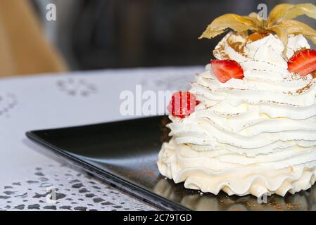 Beautiful pavlova cakes with strawberries in restaurant. Stock Photo