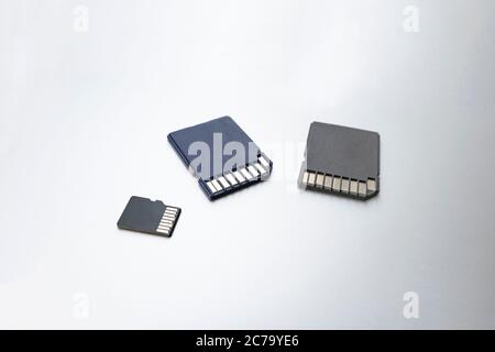 Three micro SD memory cards on gray background, selective focus. concept of memory, information storage, data storage Stock Photo
