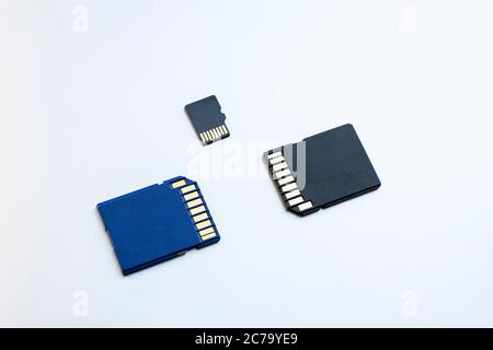 Three micro SD memory cards on gray background, close-up, top view. the concept of data storage Stock Photo