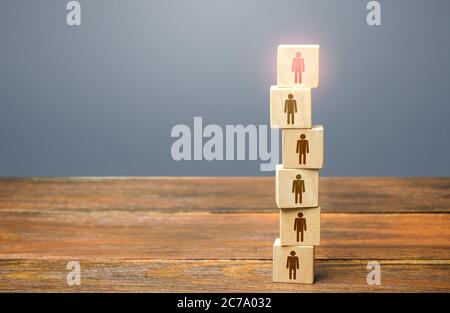 Red leader on top of a tower of people. Leadership skills. Teamwork, cooperation and collaboration. Management of effective and powerful team. Risk ma Stock Photo