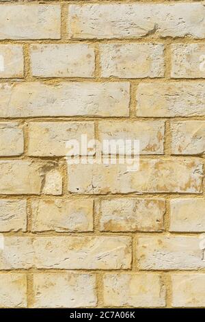Panoramic background of yellow brick wall texture. Home or office design backdrop, vertical image Stock Photo