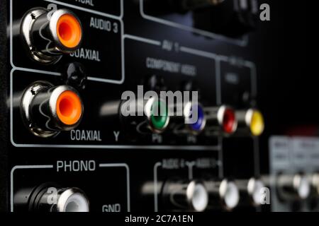 View on isolated cinch sockets of back side of black dolby surround receiver in arow Stock Photo