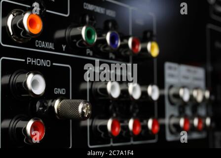 View on isolated cinch sockets of back side of black dolby surround receiver in arow Stock Photo