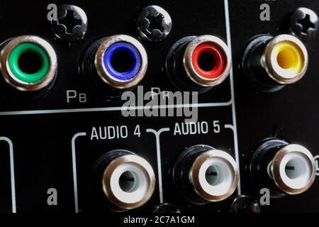 View on isolated cinch sockets of back side of black dolby surround receiver in arow Stock Photo