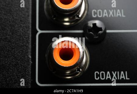 View on isolated coaxial output of back side of black dolby surround home cinema receiver (focus on output below) Stock Photo