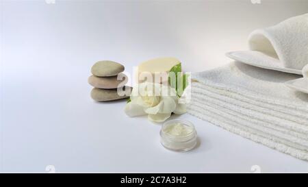 Spa setting and Spa background composition with white gardenia flower on white background. Banner Towel, candles, flowers, stones . Massage, oriental Stock Photo