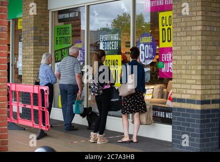 Staines-upon-Thames, Surrey, UK. 15th July, 2020. Shoppers look in the windows at the Laura Ashley store in Staines which is closing down following the Coronavirus lockdown. Credit: Maureen McLean/Alamy Stock Photo