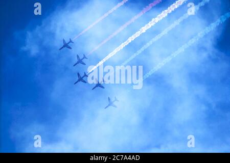 Jets flying in formation through cloud in a blue sky Stock Photo