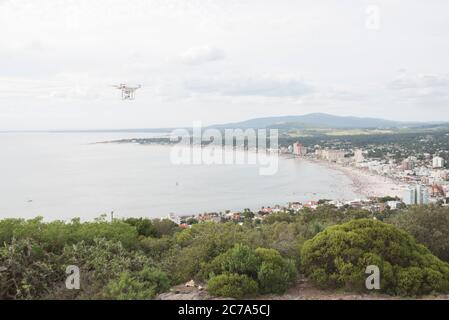 Flying drone and panoramic view of Piriapolis from the viewpoint of San Antonio hill. Attractive tourist spot on the Uruguayan coast Stock Photo