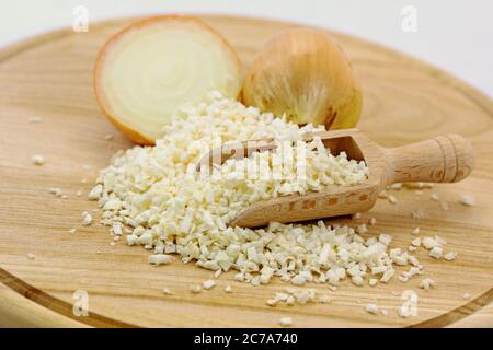 Dried onions on a wooden plate Stock Photo