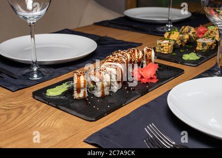 Sushi on the table in the restaurant. Served table with plates and glasses. It's a beautiful serve. Stock Photo