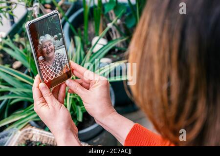 Mother's day or talking with mother in stay at home or new normal days concepts. Woman talking with her mother via video call at home. Stock Photo