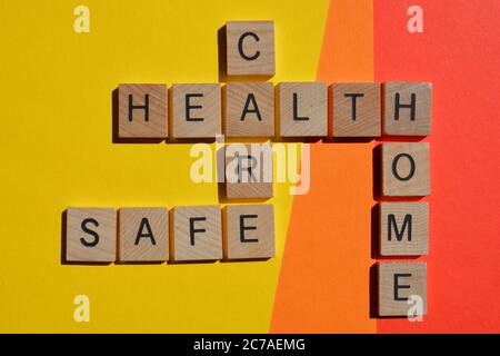 Health, Care, Safe, Home, words in wooden alphabet letters in crossword form isolated on colourful background Stock Photo