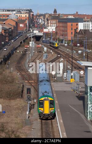 London Midland  / West Midlands Railway class 172 diesel trains passing a Birmingham Snow Hill with the city skyline above. Stock Photo