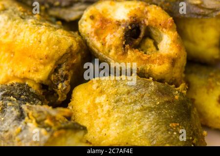 Pieces of navaga fish in batter, fried in oil in a pan. Stock Photo