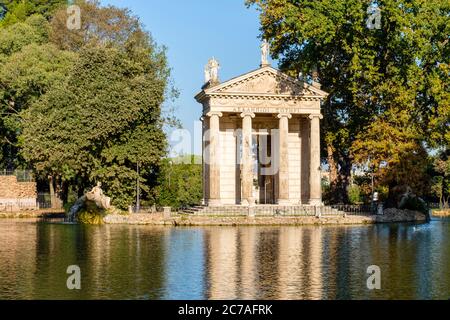 Ionic style Temple of Asclepius (Aesculapius) reflected on Laguetto di Villa Borghese, Villa Borghese gardens, Rome, Italy Stock Photo