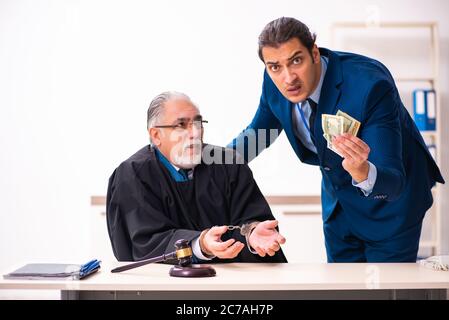 Police inspector arresting judge in court Stock Photo