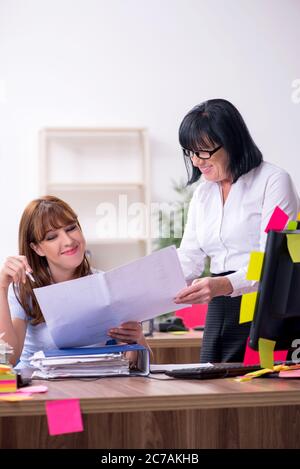 Two employees and excessive work in the office Stock Photo
