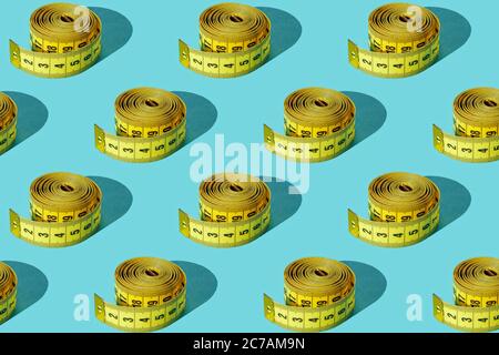 Yellow measuring tape on a green background. Set. Texture. Stock Photo