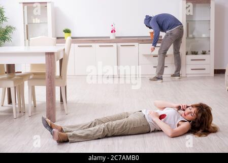 A knife in the blood, a smartphone and money dollars lie on the floor ...