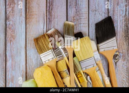 Various paint tools brush renovating the house on wooden table background Stock Photo