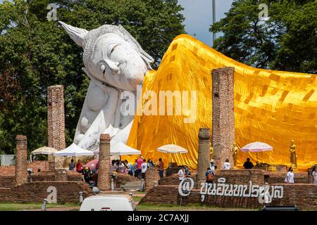 AYUTTHAYA, THAILAND, JUN 03 2020, The Reclining Buddha at Wat Khun Inthapramun. A large white Buddha statue at the historical temple, covered the gold Stock Photo