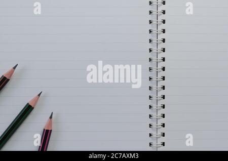 Wirebound Notebook Open Lined Paper and Pencil is On. Stock Photo