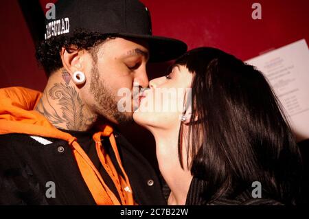 EXCLUSIVE backstage portrait of Katy Perry (r) and boyfriend Travis McCoy of Gym Class Heros kissing at the Gibson Amphitheater in Los Angeles. Credit: Jared Milgrim/The Photo Access Stock Photo