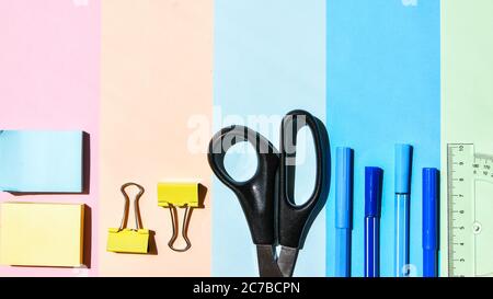 School Supplies In Frame With Colorful Paper Background. School or office stationery on colorful background. Back to School. Copy space. Stock Photo
