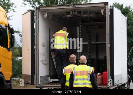 Bautzen, Germany. 16th July, 2020. Police officers inspect the loading area of a small van at the motorway parking lot 'Löbauer Wasser' on motorway 4 as part of a control mission of the Görlitz police headquarters. The inspection is intended to combat cross-border crime on the German-Polish border. Credit: Sebastian Kahnert/dpa-Zentralbild/dpa/Alamy Live News Stock Photo