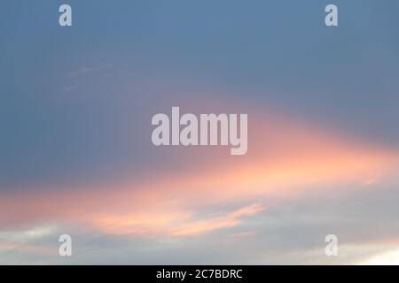 sky and cloud in blue and orange gradient colors. Colorful smooth sky in dusk. Stock Photo