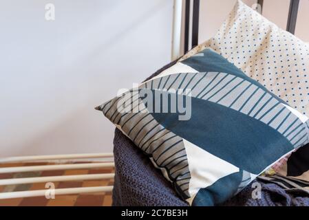 linen pillows with a geometric pattern lie on a plaid Stock Photo