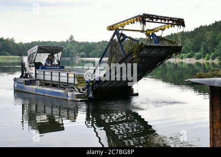 Pilsen, Czech Republic. 15th July, 2020. An aquatic weed harvester prepares to unload underwater weeds on the Big Bolevecky Pond in Pilsen, Czech Republic, on July 15, 2020. Credit: Miroslav Chaloupka/CTK Photo/Alamy Live News Stock Photo