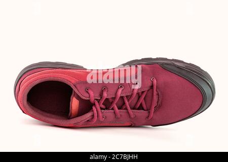 one right cheap red fabric hiking or hunting shoe isolated on white background Stock Photo