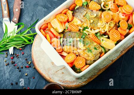 Baked fish steaks with grilled vegetables in baking dish.Delicious healthy grilled fish Stock Photo