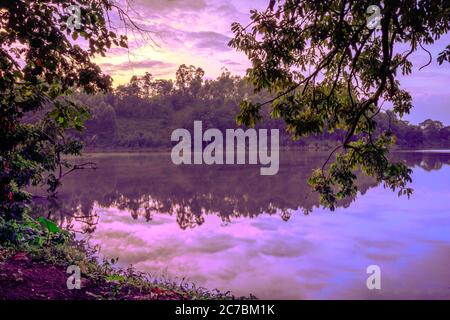 Sunrise view of Lake Nyabikere, with trees growing and the reflections on the water, Rweteera, Fort Portal, Uganda, Africa Stock Photo