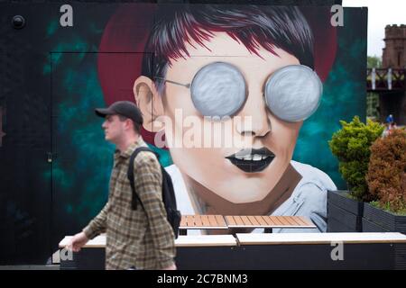 Glasgow Scotland, UK. 16th July, 2020. Pictured: New artworks and murals appear on the Clutha Bar on the Broomielaw area of Glasgow. The bar is well known for its large format artworks on the buildings exterior. The Clutha Bar was synonymous with live music, and then it was marred by tragedy when a police helicopter crashed into it the pub on November 2013, however the people of Glasgow have rallied around it, making the Bar into a living artwork and celebrating the spirit of Glasgow. Credit: Colin Fisher/Alamy Live News Stock Photo