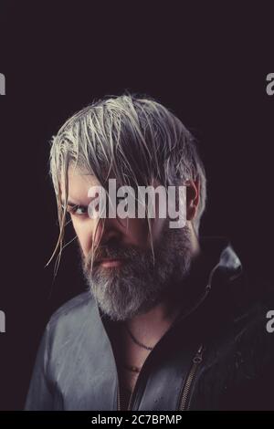 Handsome brutal man on the studio shoot in leather jacket. Stock Photo