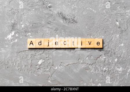 adjective word written on wood block. adjective text on cement table for your desing, concept. Stock Photo