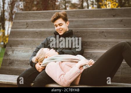 Teenage love concept. Cute brunette guy фтв young blonde girl Stock Photo