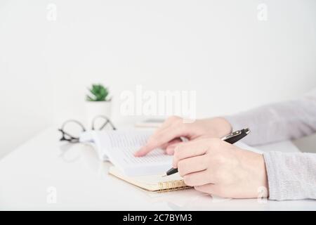 Woman searching information in book, Office Work Concept on white wall background Stock Photo