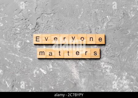 Everyone matters word written on wood block. Ever yone matterstext on cement table for your desing, Top view concept. Stock Photo