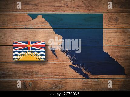 Map and flag of British Colombia, province of Canada, on wooden background, 3D illustration Stock Photo