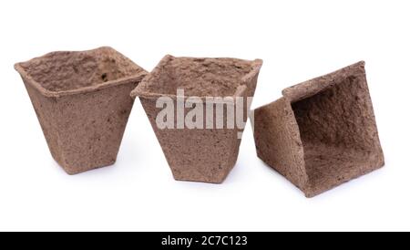 Three empty peat pots isolated on white background Stock Photo