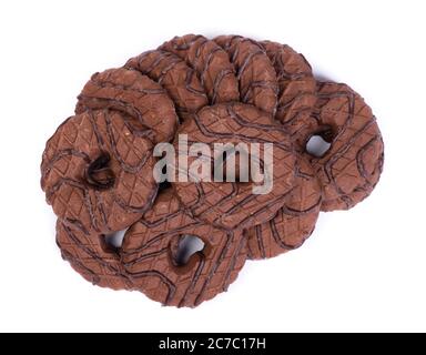 Heap of chocolate round cookies with heart-shaped hole isolated over white background Stock Photo