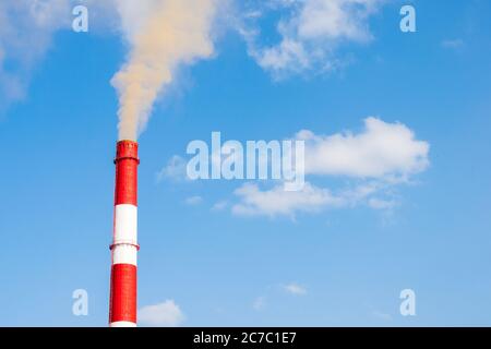 Industrial chimneys smoke smog on blue sky. Air pollution disaster concept. Day of the Planet Earth. Horizontal frame Stock Photo