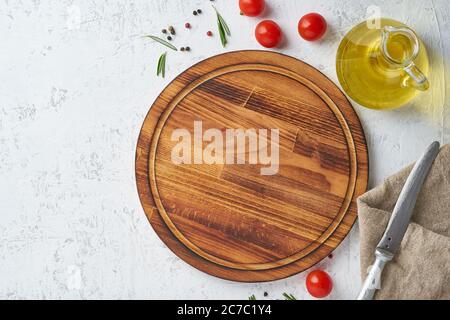 Food seasoning background. Round wooden cutting board, spices, herbs Stock Photo