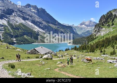 Busy hiking trail near the Oeschinen Lake (Oeschinensee) in the Swiss Alps Stock Photo